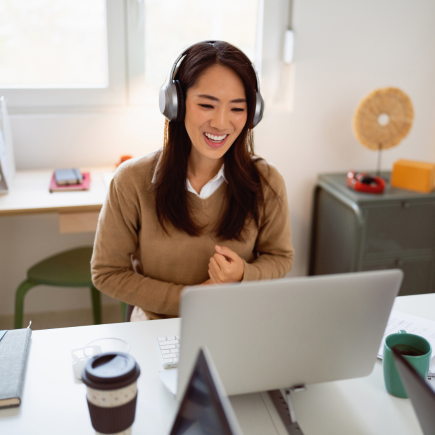 Online school teacher with headphones on leading a class of students