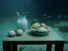 underwater art with table and fruit with a pitcher.