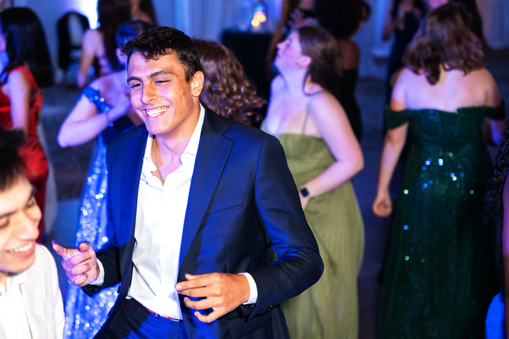 Students dancing at prom with City of Stars theme, enjoying the dance floor and photobooth